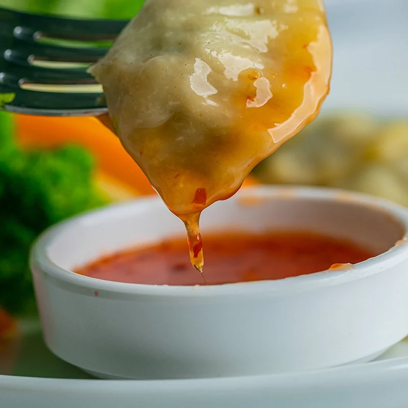 Close-up dumpling dipped in sauce