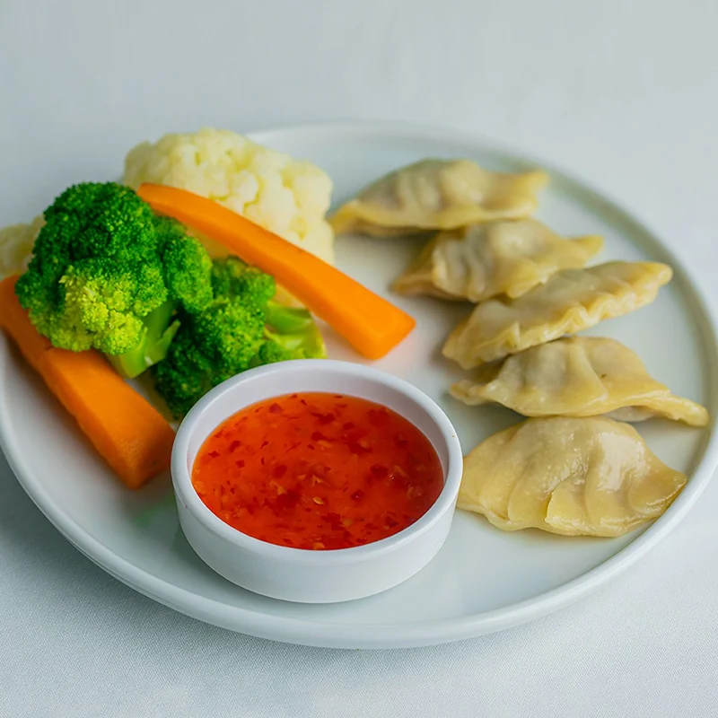 Dumplings, vegetables and dipping sauce