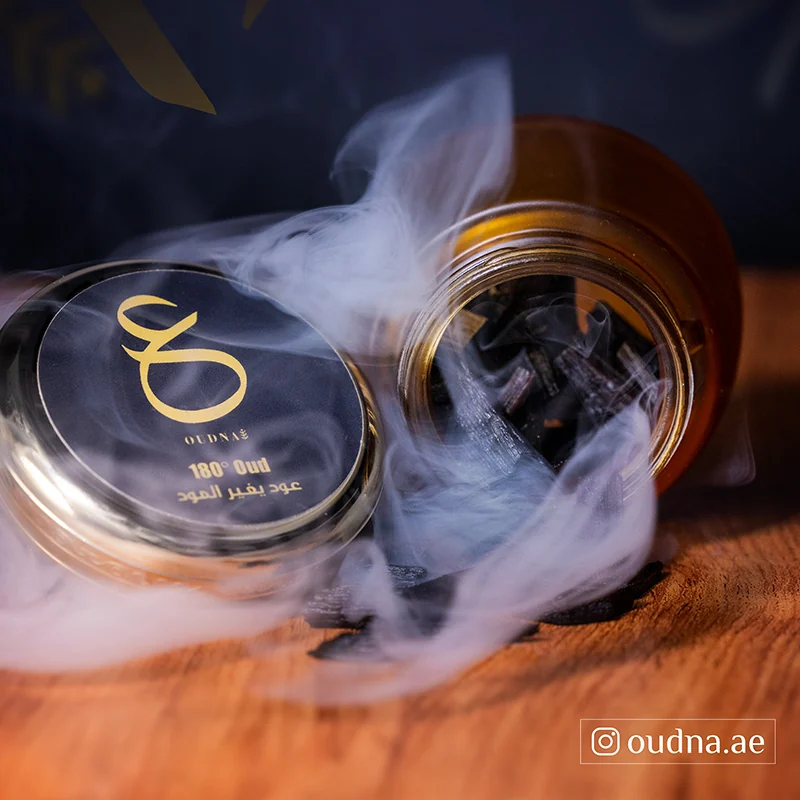 Premium oud product photograph with atmospheric smoke