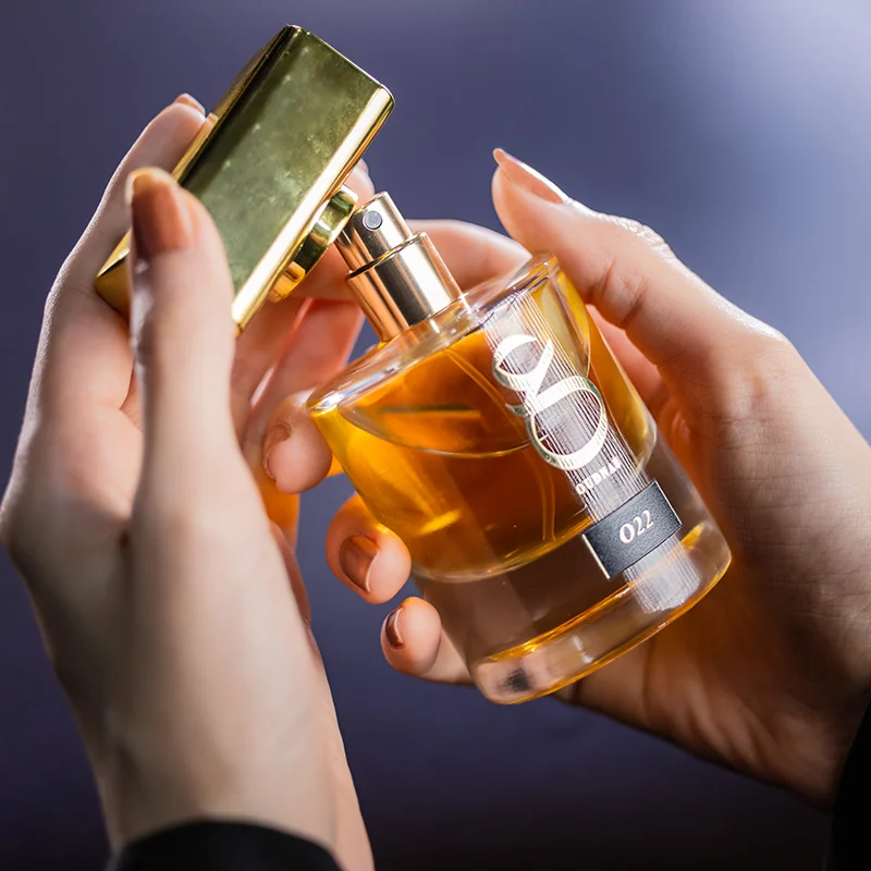 Perfume bottle held for a beauty campaign